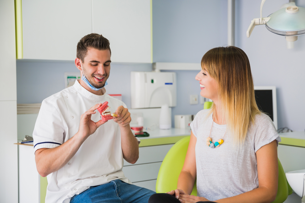 male dentist shows the patient